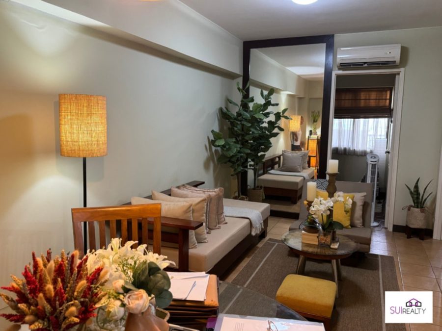 Furnished living room with sofa, floor lamp and balcony access