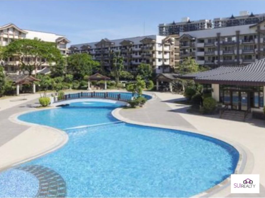 Landscaped swimming pool amenity in a low-rise condominium development